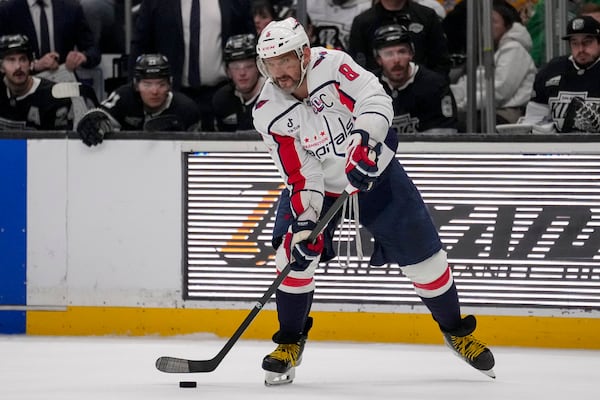 Washington Capitals left wing Alex Ovechkin (8) passes the puck during the third period of an NHL hockey game against the Los Angeles Kings Thursday, March 13, 2025, in Los Angeles. (AP Photo/Eric Thayer)