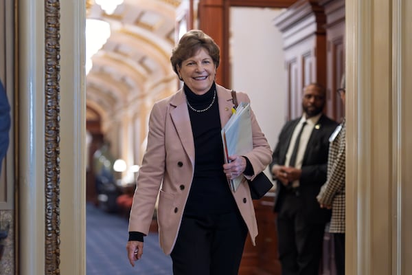 Sen. Jeanne Shaheen, D-N.H., heads to a closed-door meeting with fellow Democrats on mounting a response to the Republican-led spending bill that already passed the House, Thursday, March 13, 2025, in Washington. (AP Photo/J. Scott Applewhite)