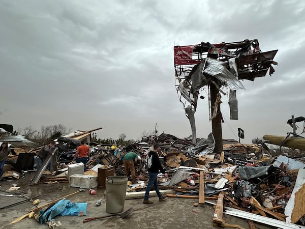 People work through the debris of the Cave City Auto Parts store on Saturday, March 15, 2025 after a severe weather storm Friday night in Cave City, Ark. (Staci Vandagriff/Arkansas Democrat-Gazette via AP)