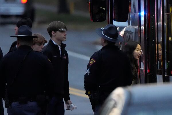 Students aboard a bus as they leave the shelter following a shooting at the Abundant Life Christian School, Monday, Dec. 16, 2024. (AP Photo/Morry Gash)