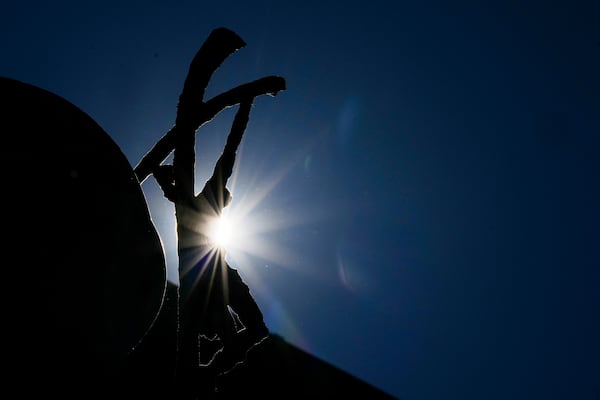 The sun shines behind the statue of Pope John Paul II in front of the Agostino Gemelli Polyclinic, in Rome, Tuesday, March 18, 2025, where Pope Francis is hospitalized since Feb. 14. (AP Photo/Andrew Medichini)