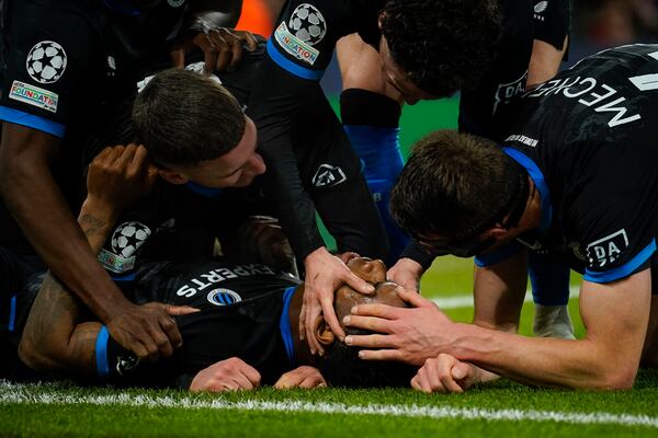 Brugge's Raphael Onyedika, bottom, celebrates with teammates after scoring the opening goal during the Champions League opening phase soccer match between Manchester City and Club Brugge at the Etihad Stadium in Manchester, Wednesday, Jan. 29, 2025. (AP Photo/Dave Thompson)