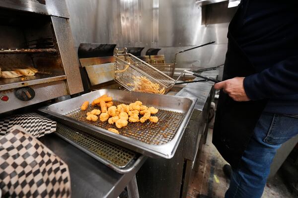 Fried shrimp are served up in the kitchen of Central Poboys in Jefferson Parish, La., a suburb of New Orleans, Friday, Jan. 24, 2025. (AP Photo/Gerald Herbert)