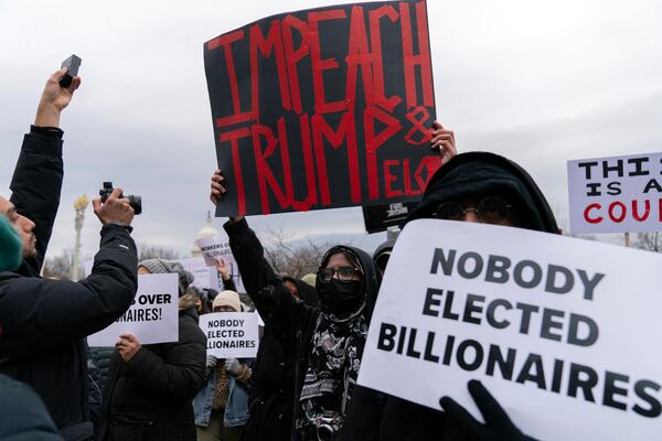 FILE - People protest against Elon Musk outside the U.S. Department of Labor in Washington, Wednesday, Feb. 5, 2025. (AP Photo/Jose Luis Magana, File)