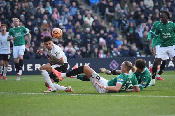 Plymouth Argyle's Maksym Talovyerov clears the ball next to Liverpool's Luis Diaz during the English FA Cup fourth round soccer match between Plymouth Argyle and Liverpool at Home Park stadium in Plymouth, England, Sunday, Feb. 9, 2025. (AP Photo/Alastair Grant)