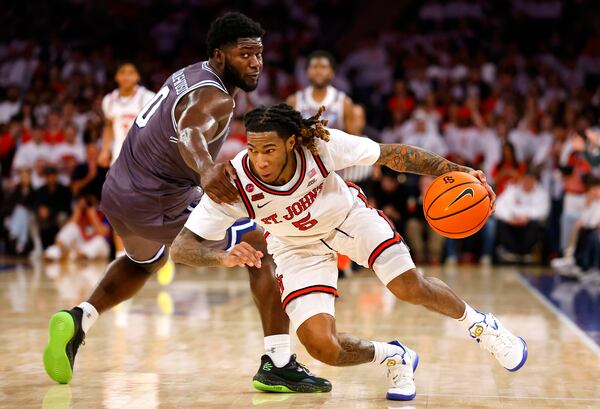 St. John's guard Deivon Smith (5) is fouled by Seton Hall guard Dylan Addae-Wusu (0) during the second half of an NCAA college basketball game, Saturday, March 1, 2025, in New York. (AP Photo/Noah K. Murray)