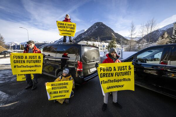 Greenpeace activists block the access road to the heliport during a protest in Davos Dorf during the 55th annual meeting of the World Economic Forum, WEF, in Davos, Switzerland, Monday, Jan. 20, 2025. (Michael Buholzer/Keystone via AP)