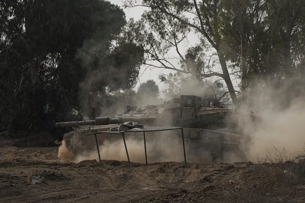 An Israeli tank moves along the border with the Gaza Strip in southern Israel on Thursday, Jan. 16, 2025. (AP Photo/Tsafrir Abayov)