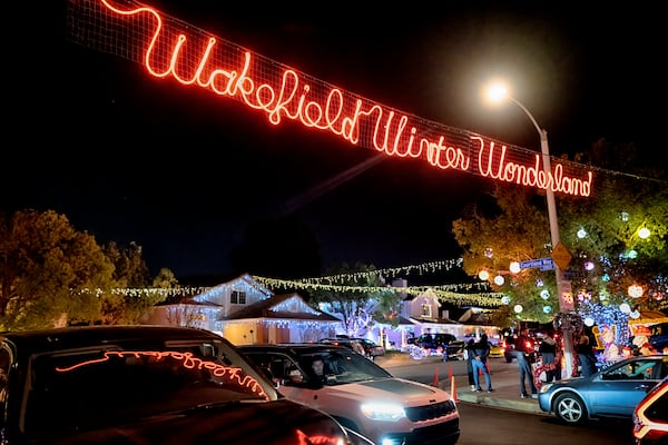 Local residents drive through the Wakefield Winter Wonderland neighborhood decorated with Christmas lights in Santa Clarita, Calif. on Dec. 17, 2024. (AP Photo/Richard Vogel)