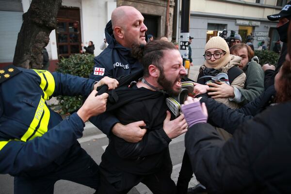 FILE - Police detain a protester during a rally against the results of the parliamentary election in Tbilisi, Georgia, on Nov. 19, 2024. (AP Photo/Zurab Tsertsvadze, File)