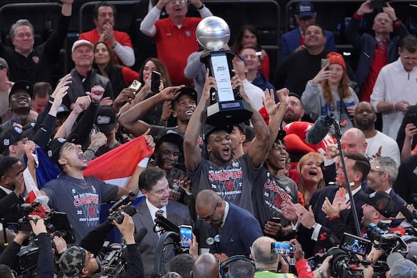 St. John's Zuby Ejiofor, left, celebrates as Zuby Ejiofor holds the tournament trophy after an NCAA college basketball game against Creighton in the championship of the Big East Conference tournament Saturday, March 15, 2025, in New York. (AP Photo/Frank Franklin II)