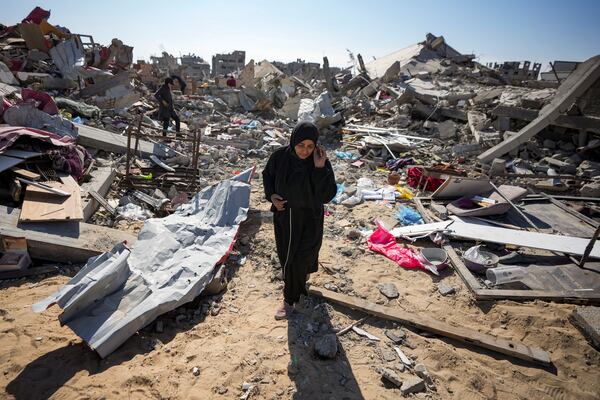 Manual Aslim walks through the rubble of her destroyed home, in Rafah, southern Gaza Strip, Tuesday, Jan. 21, 2025, days after the ceasefire deal between Israel and Hamas came into effect. (AP Photo/Abdel Kareem Hana)