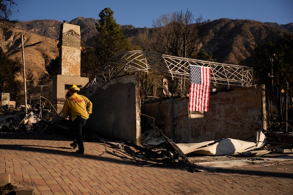 A firefighter inspects homes destroyed by the Eaton Fire in in Altadena, Calif., is seen Wednesday, Jan 15, 2025. (AP Photo/John Locher)