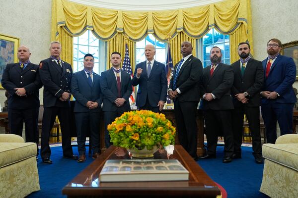 President Joe Biden, center, poses for a photo with Medal of Valor honorees in the Oval Office of the White House in Washington, Friday, Jan. 3, 2025. Honorees are, from left, Lt. John Vanderstar of the New York City Fire Department, Firefighter Brendan Gaffney of the New York City Fire Department, Sgt. Tu Tran, of the Lincoln, Neb. Police Department, Det. Michael Collazo, of the Nashville, Tenn. Police Department, Chief John Drake, receiving on behalf of Officer Rex Engelbert, of the Nashville, Tenn. Police Department, Sgt. Jeffrey Mathes, of the Nashville, Tenn. Police Department, Det. Zachary Plese, of the Nashville, Tenn. Police Department, and Det. Ryan Cagle, of the Nashville, Tenn. Police Department. (AP Photo/Susan Walsh)