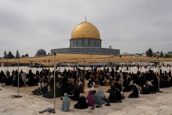 Palestinian women sit under the shade before Friday prayers at the Al-Aqsa Mosque compound in the Old City of Jerusalem, during the Muslim holy month of Ramadan, Friday, March 14, 2025. (AP Photo/Mahmoud Illean)