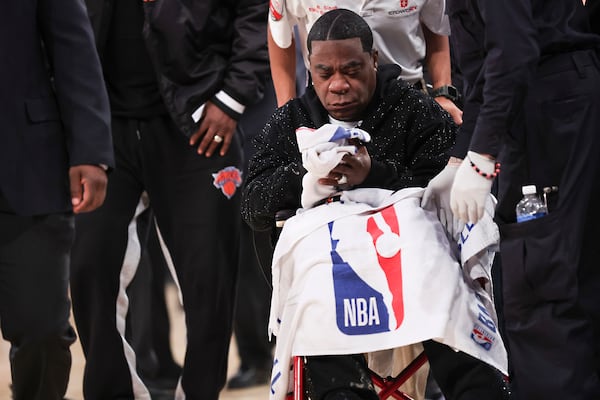 Actor-comedian Tracy Morgan sits in a wheelchair as he is tended to after he became ill and had to leave an NBA basketball game between the New York Knicks and Miami Heat in a wheelchair due to illness, Monday, March 17, 2025, in New York. (AP Photo/Heather Khalifa)