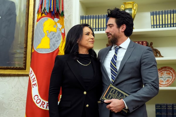 Tulsi Gabbard stands with her husband Abraham Williams before she is sworn in as the Director of National Intelligence in the Oval Office at the White House, Wednesday, Feb. 12, 2025, in Washington. (Photo/Alex Brandon)