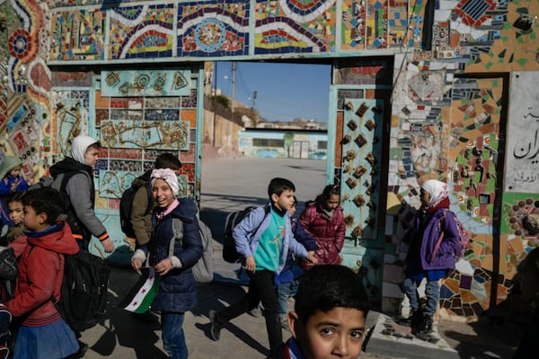 Syrian children leave their school after class in central Damascus Thursday Dec. 19, 2024. (AP Photo/Leo Correa)