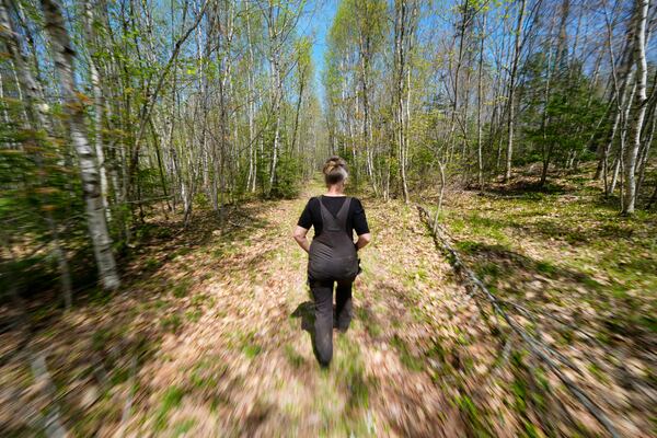 Heather Donahue walks on a rural road, Tuesday, May 13, 2025, in Freedom, Maine. (AP Photo/Robert F. Bukaty)