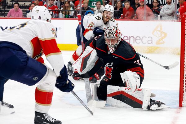 Carolina Hurricanes goaltender Pyotr Kochetkov (52) watches the puck from between Florida Panthers' A.J. Greer (10) an Matthew Tkachuk (19) during the third period of Game 2 of the NHL hockey Stanley Cup Eastern Conference finals in Raleigh, N.C., Thursday, May 22, 2025. (AP Photo/Karl DeBlaker)
