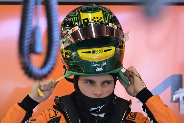 McLaren driver Oscar Piastri of Australia puts his helmet on during qualifying at the Australian Formula One Grand Prix at Albert Park, in Melbourne, Australia, Saturday, March 15, 2025. (Tracey Nearmy/Pool Photo via AP)