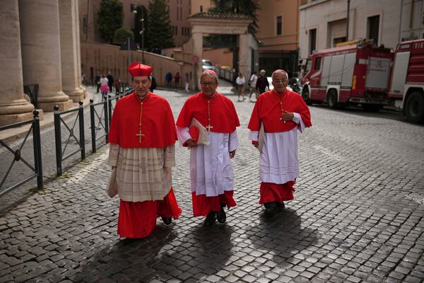 From right, Cardinals Gregorio Rosa Chavez, Luis Jose Rueda Aparicio and Ruben Salazar Gomez arrive to the Vatican, Friday, May 9, 2025, a day after Pope Leo XIV was elected history's first North American pope. (AP Photo/Francisco Seco)