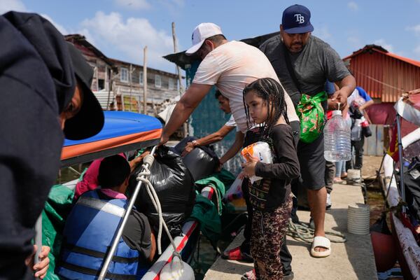 Venezuelan migrants board boats to Colombia on Panama's Caribbean coastal island of Gardi Sugdub, Sunday, Feb. 23, 2025, after turning back from southern Mexico where they gave up hopes of reaching the U.S. amid President Trump's crackdown on migration. (AP Photo/Matias Delacroix)