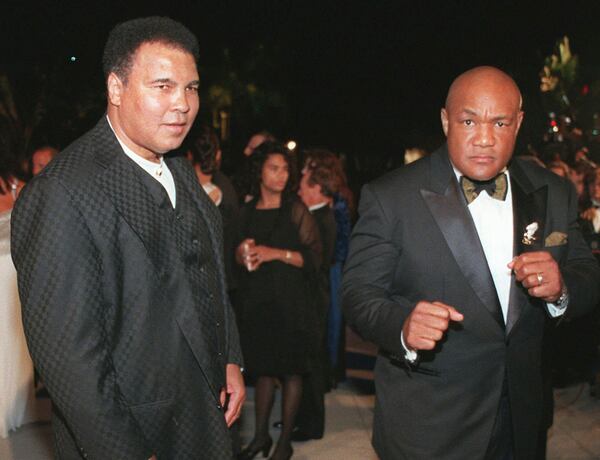 FILE - Boxing greats Muhammad Ali, left, and George Foreman arrive at a Vanity Fair Oscar party in West Hollywood, Calif., on March 24, 1997. (AP Photo/E.J. Flynn, File)