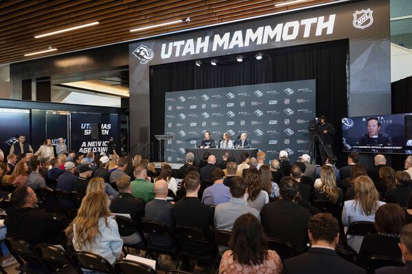 Chairman of Smith Entertainment Group Ryan Smith and co-founder Ashley Smith join NHL Commissioner Gary Bettman, from left, as they announce the Utah Mammoth as the new name and branding identity of Utah's NHL franchise, Wednesday, May 7, 2025, in Salt Lake City. (AP Photo/Melissa Majchrzak)