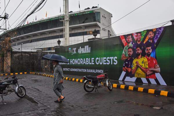 A Pakistani walks past the Pindi Cricket Stadium, where a suspected Indian drone crashed in the parking area, in Rawalpindi, Pakistan, Thursday, May 8, 2025. (AP Photo/W.K. Youszai)