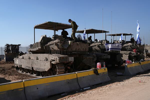 Israeli soldiers work in a staging area on the Israel-Gaza border after returning from the Gaza Strip, Saturday, Jan. 18, 2025, a day ahead of a ceasefire between Israel and Hamas. (AP Photo/Tsafrir Abayov)