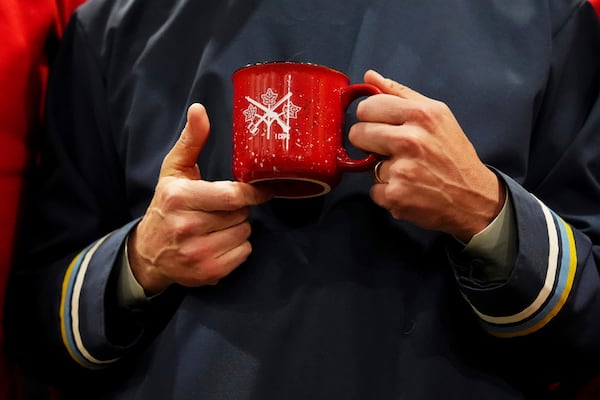 Canada Prime Minister Mark Carney holds a mug gifted to him by the Canadian Rangers after making an announcement at a Canadian Armed Forces forward-operating location in Iqaluit, Nunavut, on Tuesday, March 18, 2025. (Sean Kilpatrick/The Canadian Press via AP)