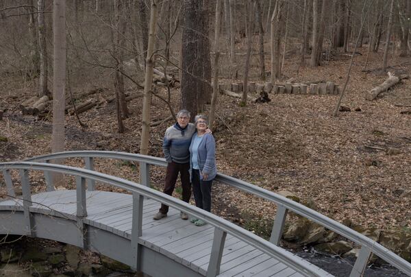 Jon Randall, left, and Mariane Randall, right, pose for a portrait at their home on Saturday, March 22, 2025, in Webster, N.Y. (Toni Duncan via AP)