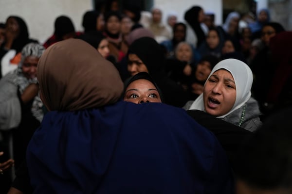 A mourner cries after taking the last look at the body of a relative, one of eight Palestinians killed, during their funeral following the withdrawal of the Israeli army, in the West Bank city of Tulkarem, Thursday, Dec. 26, 2024. (AP Photo/Matias Delacroix)