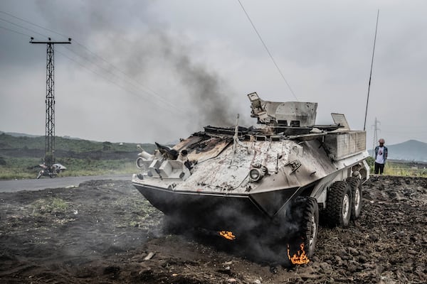 A UN armoured personnel carrier burns during clashes with M23 rebels outside Goma, Democratic Republic of the Congo, Saturday, Jan. 25, 2024. (AP Photo/Moses Sawasawa)