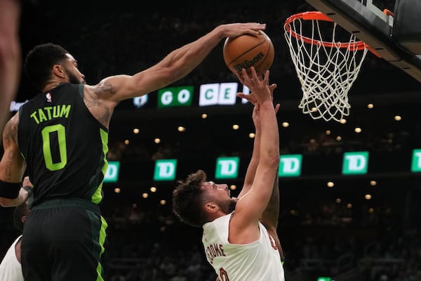 Boston Celtics forward Jayson Tatum (0) blocks a shot by Cleveland Cavaliers guard Ty Jerome, right, during the first half of an NBA basketball game, Friday, Feb. 28, 2025, in Boston. (AP Photo/Charles Krupa)