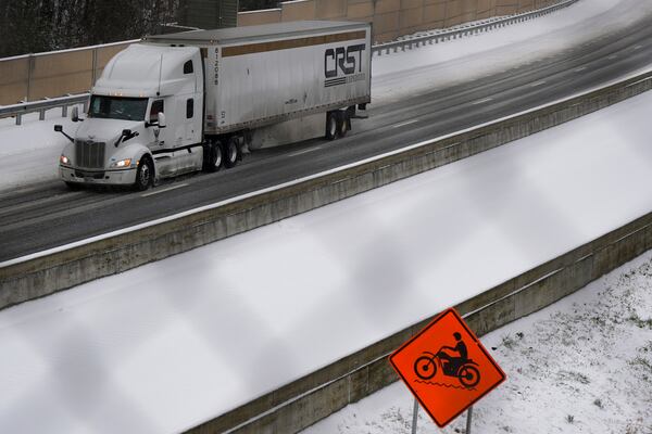 A vehicle moves slowly on Interstate 75 during a winter storm, Friday, Jan. 10, 2025, in Kennesaw, Ga. (AP Photo/Mike Stewart)