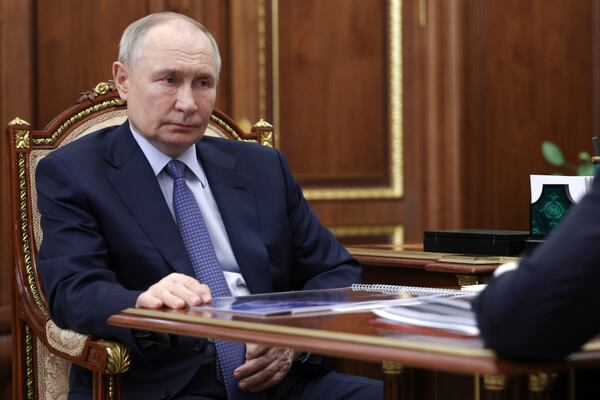 Russian President Vladimir Putin listens to Promsvyazbank CEO Pyotr Fradkov during their meeting at the Kremlin in Moscow, Russia, on Thursday, May 15, 2025. (Alexander Kryazhev, Sputnik, Kremlin Pool Photo via AP)