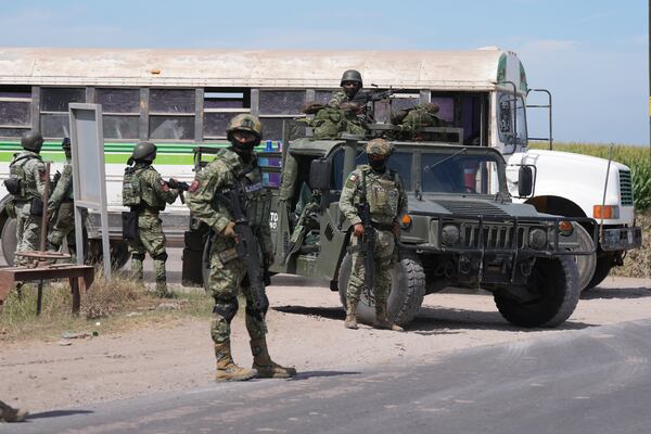 Soldiers patrol a highway in Villa Juarez, outside of Culiacan, Sinaloa state, Mexico, Wednesday, Feb. 26, 2025. (AP Photo/Fernando Llano)