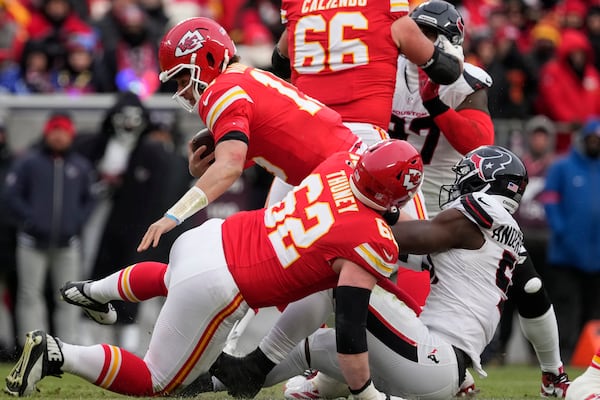 Kansas City Chiefs quarterback Patrick Mahomes (15) is sacked by Houston Texans defensive end Will Anderson Jr., right, as Chiefs guard Joe Thuney (62) assists during the first half of an NFL football AFC divisional playoff game Saturday, Jan. 18, 2025, in Kansas City, Mo. (AP Photo/Ed Zurga)