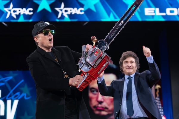 Elon Musk, left, receives a chainsaw from Argentina's President Javier Milei as they arrive speaks at the Conservative Political Action Conference, CPAC, at the Gaylord National Resort & Convention Center, Thursday, Feb. 20, 2025, in Oxon Hill, Md. (AP Photo/Jose Luis Magana)