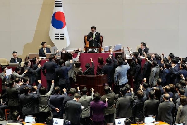 Lawmakers of the ruling People Power Party protest to South Korea's National Assembly Speaker Woo Won Shik, top center, during a plenary session for the impeachment motion against South Korean acting President Han Duck-soo at the National Assembly in Seoul, South Korea, Friday Dec. 27, 2024. (AP Photo/Ahn Young-joon)