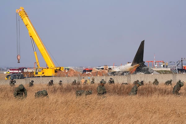 South Korean army soldiers work outside of Muan International Airport in Muan, South Korea, Sunday, Dec. 29, 2024. (AP Photo/Ahn Young-joon)