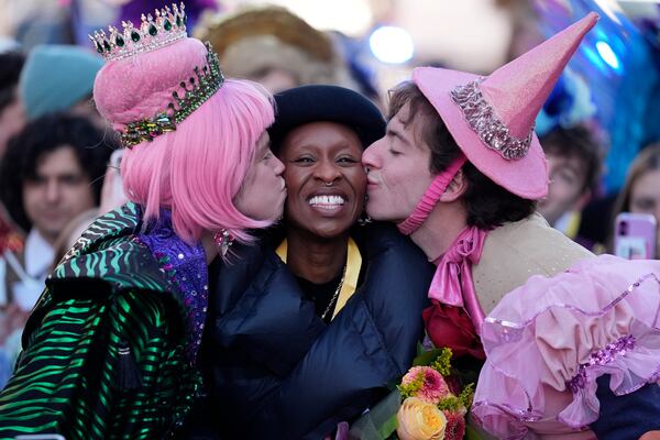 Harvard University's Hasty Pudding Theatricals Woman of the Year Cynthia Erivo smiles while kissed by two character actors during a parade in her honor, Wednesday, Feb. 5, 2025, in Cambridge, Mass. (AP Photo/Charles Krupa)