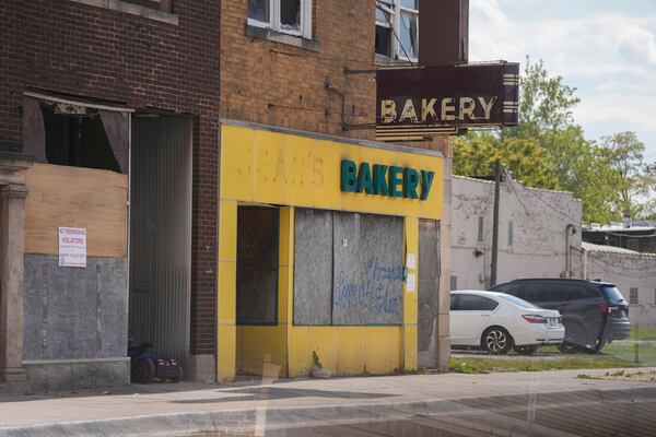 A shuttered bakery is seen near the Pace Harvey Transportation Center, Thursday, May 29, 2025, in Harvey, Ill. (AP Photo/Erin Hooley)