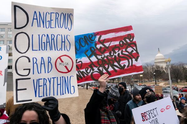 People protest during a rally against Elon Musk outside the U.S. Department of Labor in Washington, Wednesday, Feb. 5, 2025. (AP Photo/Jose Luis Magana)