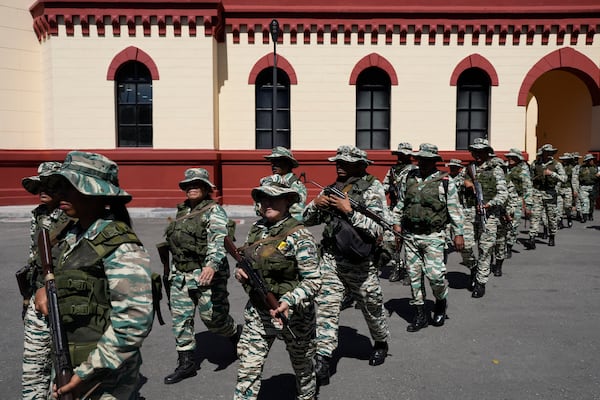 Bolivarian Militia members leave the 4F Military Museum for a gathering of security forces at Miraflores presidential palace in Caracas, Venezuela, Tuesday, Jan. 7, 2025, ahead of the presidential inauguration. (AP Photo/Matias Delacroix)