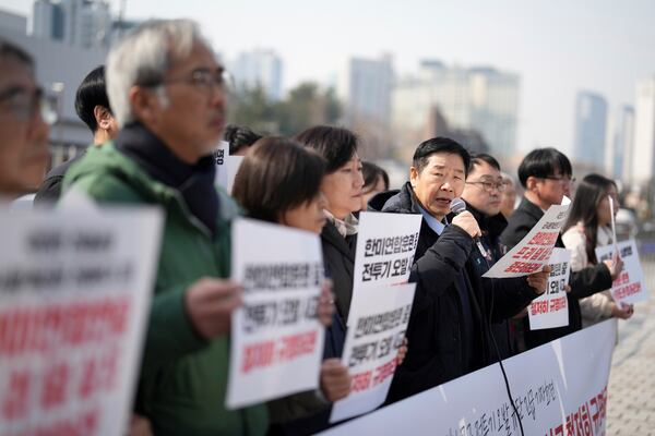 Protesters attend a press conference demanding to stop the upcoming Freedom Shield military exercise between the U.S. and South Korea and also demanding to investigate the cause thoroughly about fighter jets accidentally dropped eight bombs on a civilian area, in Seoul, South Korea, Friday, March 7, 2025. Banners read "Stop the Freedom Shield military exercise between the U.S. and South Korea." (AP Photo/Lee Jin-man)