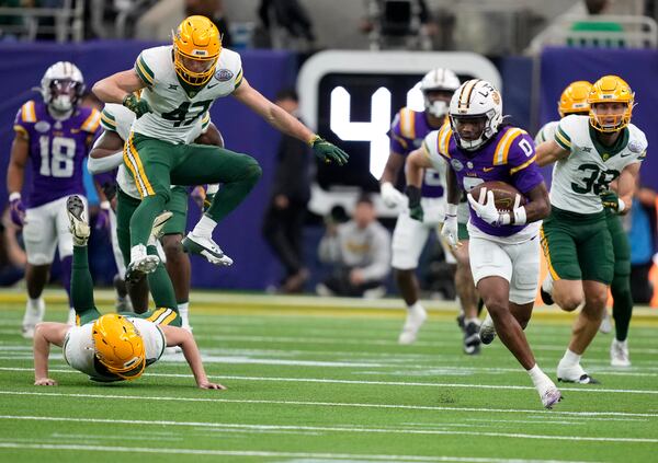 LSU wide receiver Zavion Thomas (0) returns a kickoff for a touchdown against Baylor during the first half of the Texas Bowl NCAA college football game Tuesday, Dec. 31, 2024, in Houston. (Brett Coomer/Houston Chronicle via AP)