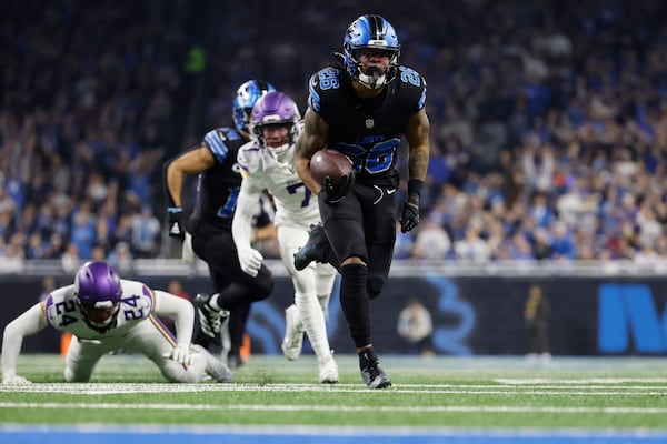 Detroit Lions running back Jahmyr Gibbs (26) runs for a touchdown against the Minnesota Vikings during the first half of an NFL football game Sunday, Jan. 5, 2025, in Detroit. (AP Photo/Rey Del Rio)